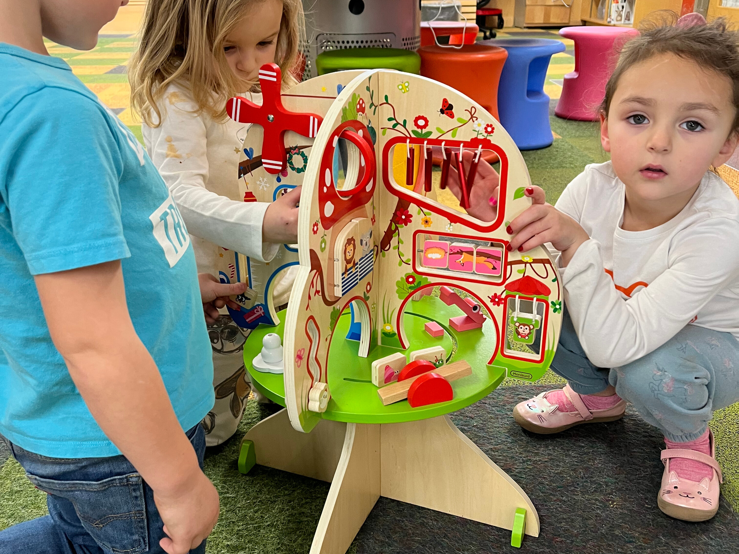 Kids playing with wooden activity toy