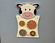 4 spinning wheels on a cow shaped wall panel