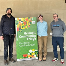 3 people in front of community fridge